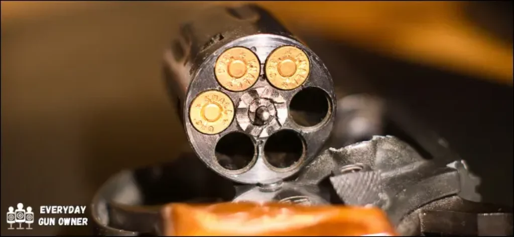 close up of revolver cylinder with 3 rounds loaded