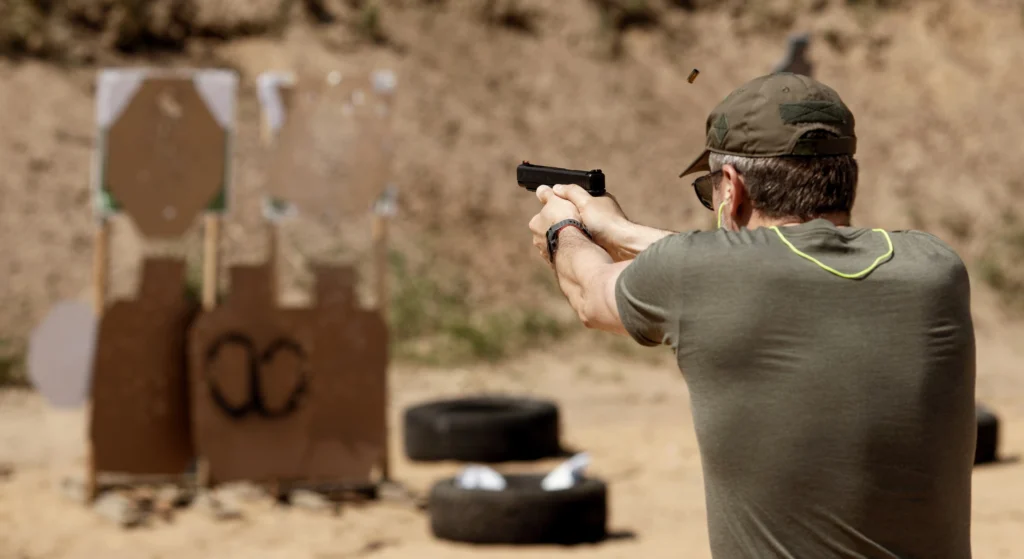 man shooting gun outside