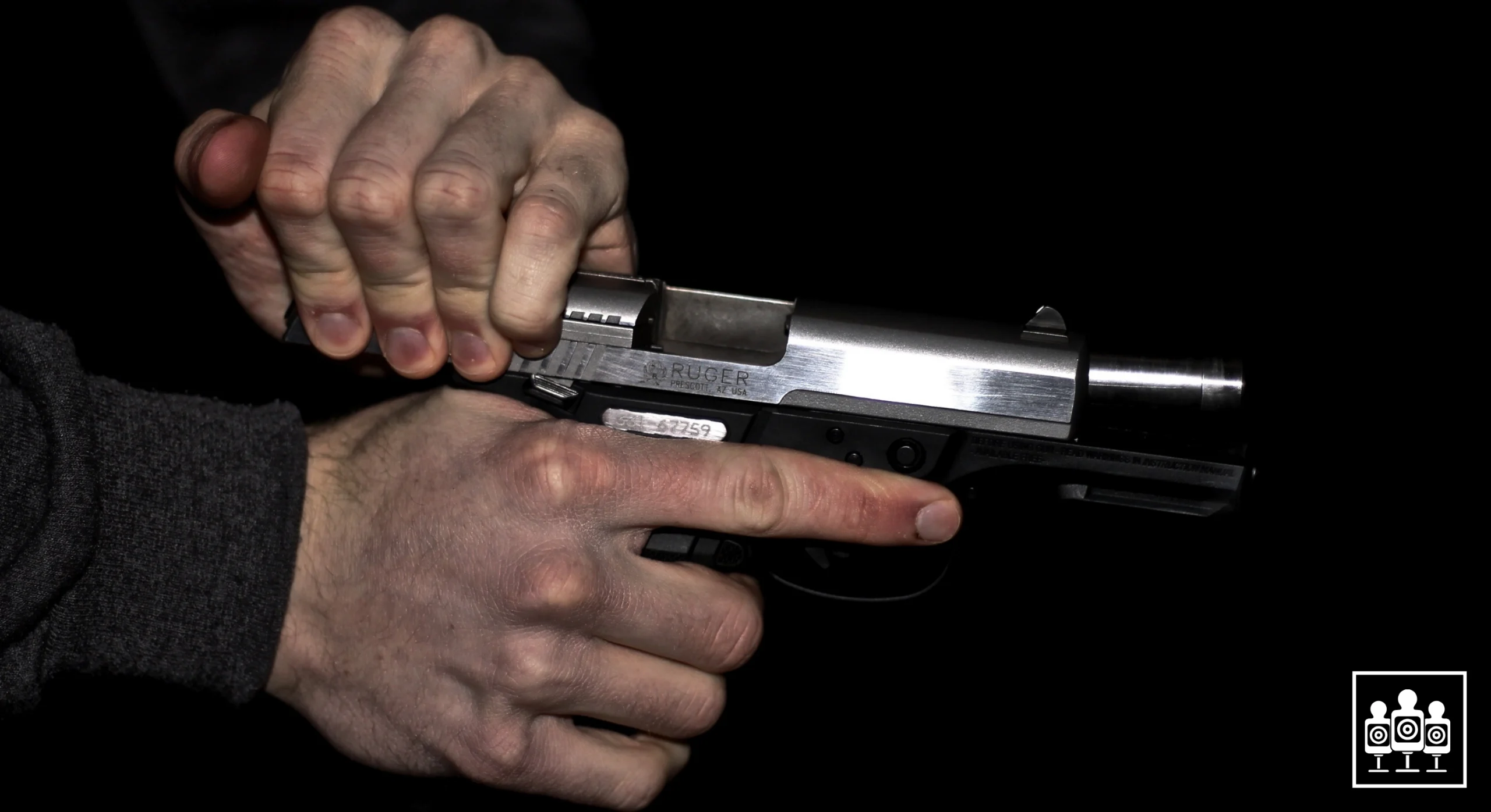 Man pulling slide back on Ruger handgun