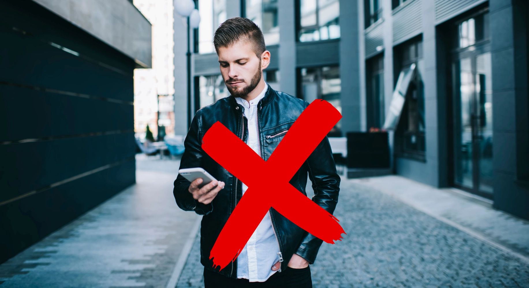 man walking while looking at his phone