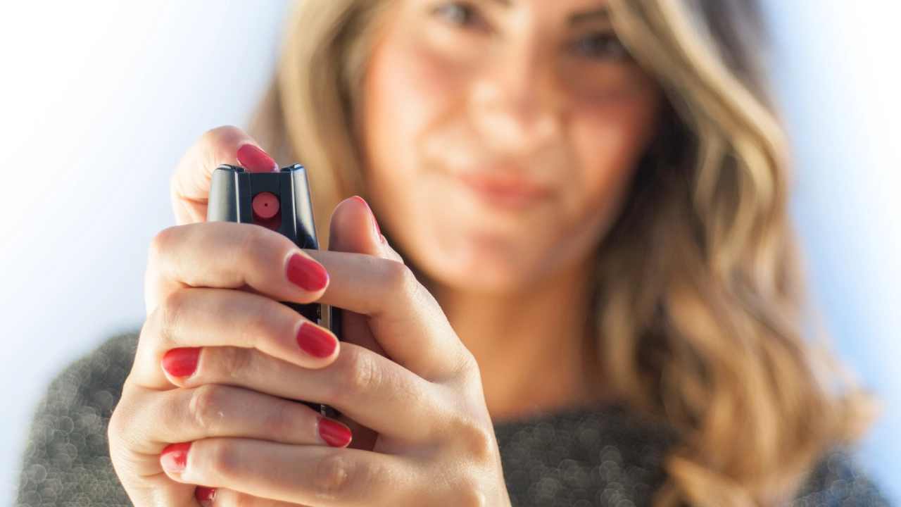 woman holding pepper spray