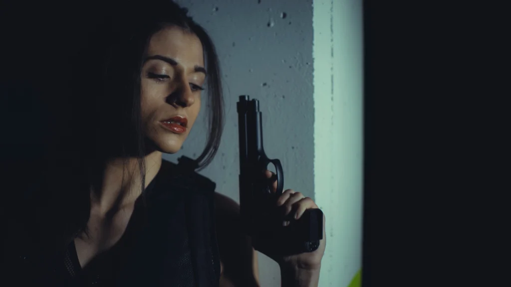 woman holding a gun in her home